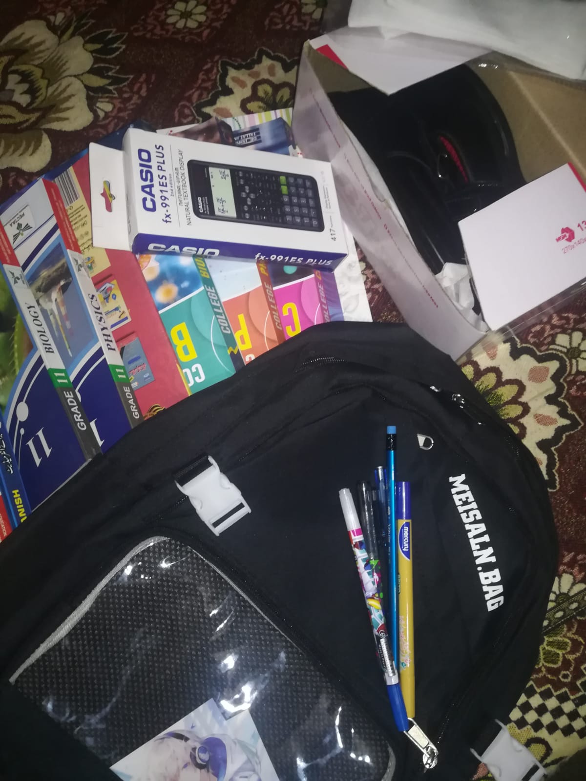 A backpack with textbooks and a scientific calculator